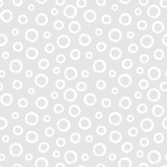 Black and white seamless pattern with rings in brush stroke technique. Abstract background with hand painted circles.