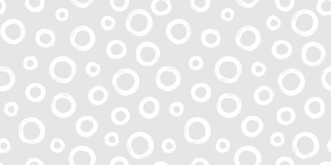 Black and white seamless pattern with rings in brush stroke technique. Abstract background with hand painted circles.