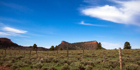 Fototapeta na wymiar Wide view of the road through Bears Ears National Monument, showing both the west butte (right) and the east butte (left) from the eastern side