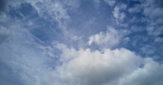 4K sky timelapse. Several layers of fluffy clouds moving to different directions.