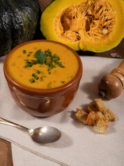 Pumpkin broth on wooden background