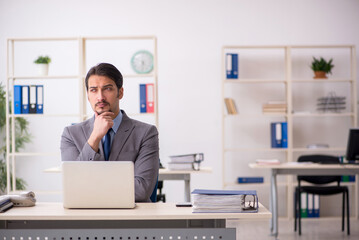 Young male employee working in the office