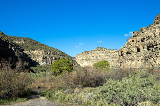 Plateau Creek flows along the scenic byway past sheer cliffs on Grand Mesa in Colorado