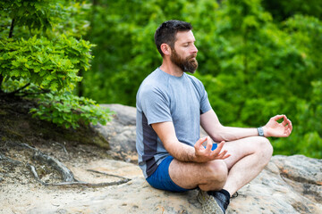 Naklejka na ściany i meble young man meditating outdoors
