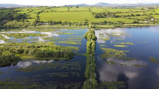 A walkway on water an aerial footage on a sunny day with cloud reflections
