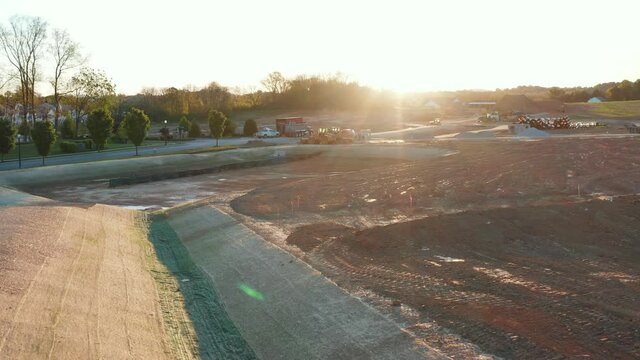 Swale created for storm water management system. Excavation of land necessary for housing development and street expansion in USA.