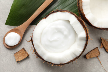 Ripe coconut and cream on light grey table, flat lay