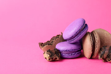 Pile of delicious colorful macarons on pink background. Space for text