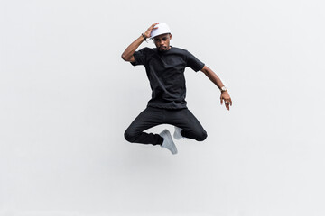 Fototapeta na wymiar Young man in black doing a jump shot