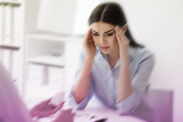 Young woman suffering from migraine in hospital