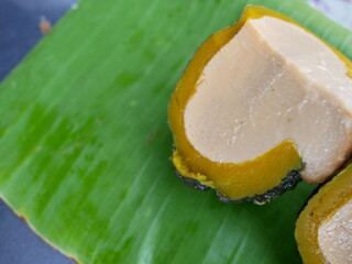 Fototapeta na wymiar egg custard in pumpkin on banana leaf at food market.