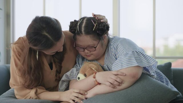 50p frame rate footage ,Authentic of happy family with teen girl down syndrome is who tease their father and mother while living a comfortable life in their home. Concept of mental health good.
