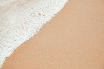 Soft wave on the sand beach, on vacation with a sunny day, at the tropical beach, of Phuket Thailand. Summer background concept.