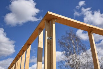 Wood frame residential building under construction.Building construction, wood framing structure at new property development site.new home currently under construction against blue sky.mortgage, loan.