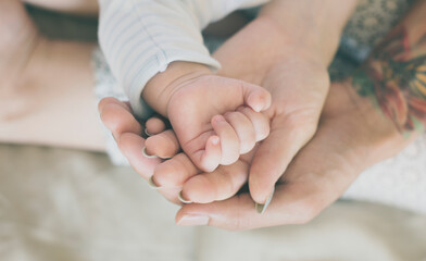 Closeup of family hands holding each other with love