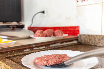 homemade raw hamburger preparing to go into the pan