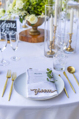 Groom Place Card Dried Romantic Wedding Table Top Layout Table Spread no people no human tropical location with gold cutlery and scenic view leaves and leaf, bride and groom