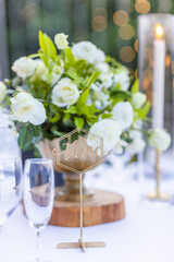 Romantic Wedding Table Top Layout Table Spread no people tropical location with gold cutlery white table cloth and scenic view of sunset with copy space tablescape, beautiful paradise setting
