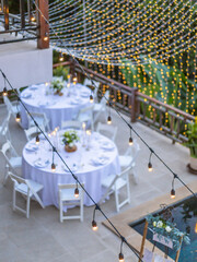 Romantic Wedding Table Top Layout Table Spread no people tropical location with gold cutlery white table cloth and scenic view of sunset with copy space tablescape, beautiful paradise setting