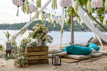 Romantic Wedding Table Top Layout Table Spread no people tropical location with gold cutlery and scenic view of sunset on the beach