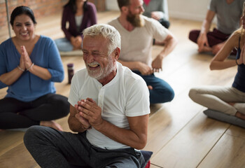 Fototapeta na wymiar Happy senior man in a yoga class