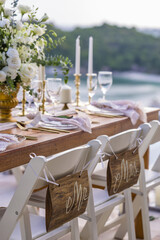 Romantic Wedding Table Top Layout Table Spread no people tropical location with gold cutlery and scenic sea view with copy space