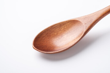 Empty wooden spoon on white background