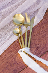Romantic Wedding Table Top Layout Table Spread with flowers no people with gold cutlery white table cloth and scenic view of sunset and blue skies with copy space tablescape