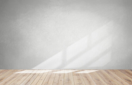 Gray wall in an empty room with a wooden floor