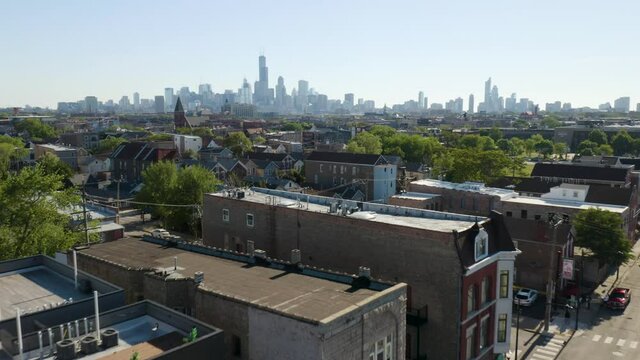 Aerial View of Pilsen Neighborhood of Chicago. Beautiful Brick Homes at Sunrise. City Skyline in Background