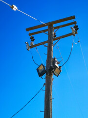 Wooden telegraph post with added lighting feature, located in a small, rural town in Australia.