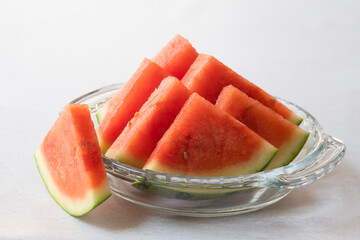Bowl of watermelon slices on kitchen table, fruit salad, healthy dessert