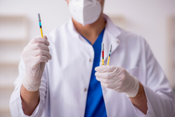 Young male doctor in vaccination concept