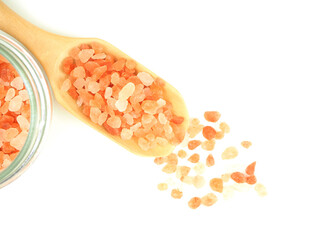 Top view, Himalayan pink salt in wooden scoop with glass bottle isolated on a white background..