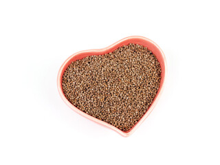 Top view, flat lay of Perilla seed in heart-shape red ceramic bowl isolated on a white background. Healthy food...