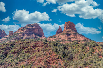 Aerial view of famous Sedona red rock formations: cathedral rock, bell rock, courthouse butte in Arizona with blue cloudy sky