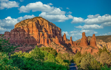 Aerial view of famous Sedona red rock formations: cathedral rock, bell rock, courthouse butte in Arizona with blue cloudy sky