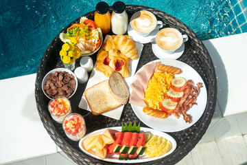 Breakfast in swimming pool, floating breakfast with thai food eggs benedict top view side pool...