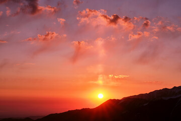 Magical atmosphere of the sunrise over the mountain ridges