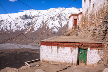 Modest ascetic housing of monks in the ancient Tibetan Buddhist Key Gompa monastery at the Spiti Valley, Himachal Pradesh, India; mounted electric cable network