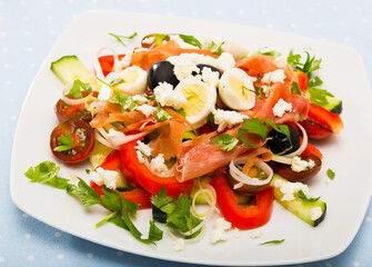 Dish of Bulgarian cuisine Shepherd salad with fresh vegetables, brynza (salted goat cheese) and prosciutto