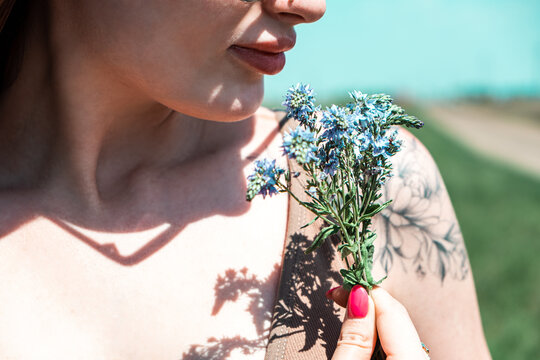 woman smelling flowers