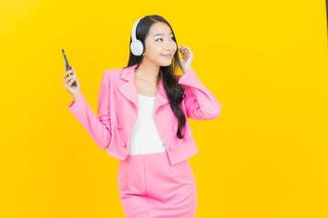 Portrait beautiful young asian woman with headphone and smart phone for listen music