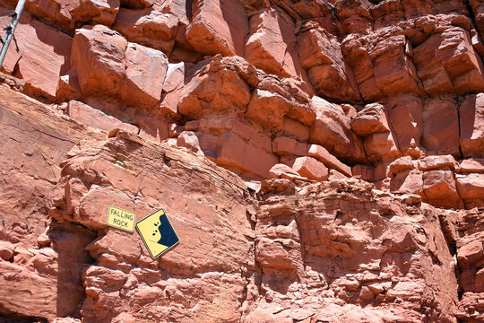 Sign With The English Words FALLING ROCK On A Red Rock Wall