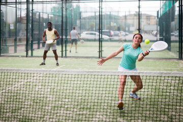 Two sports women playing padel on the tennis court