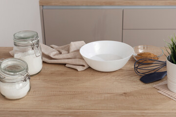 Concept of vegetarian baking background in modern home kitchen interior in light colors. Ingredients for cooking: rice flour, coconut milk, coconut palm sugar.