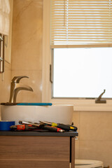Plumber repairs bathroom sink