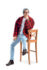 Fashionable young man sitting on chair against white background