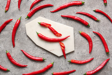 Composition with hot chili pepper on grey background