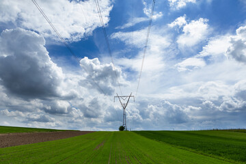 Fototapeta na wymiar electricity transmission pylon silhouetted against blue sky